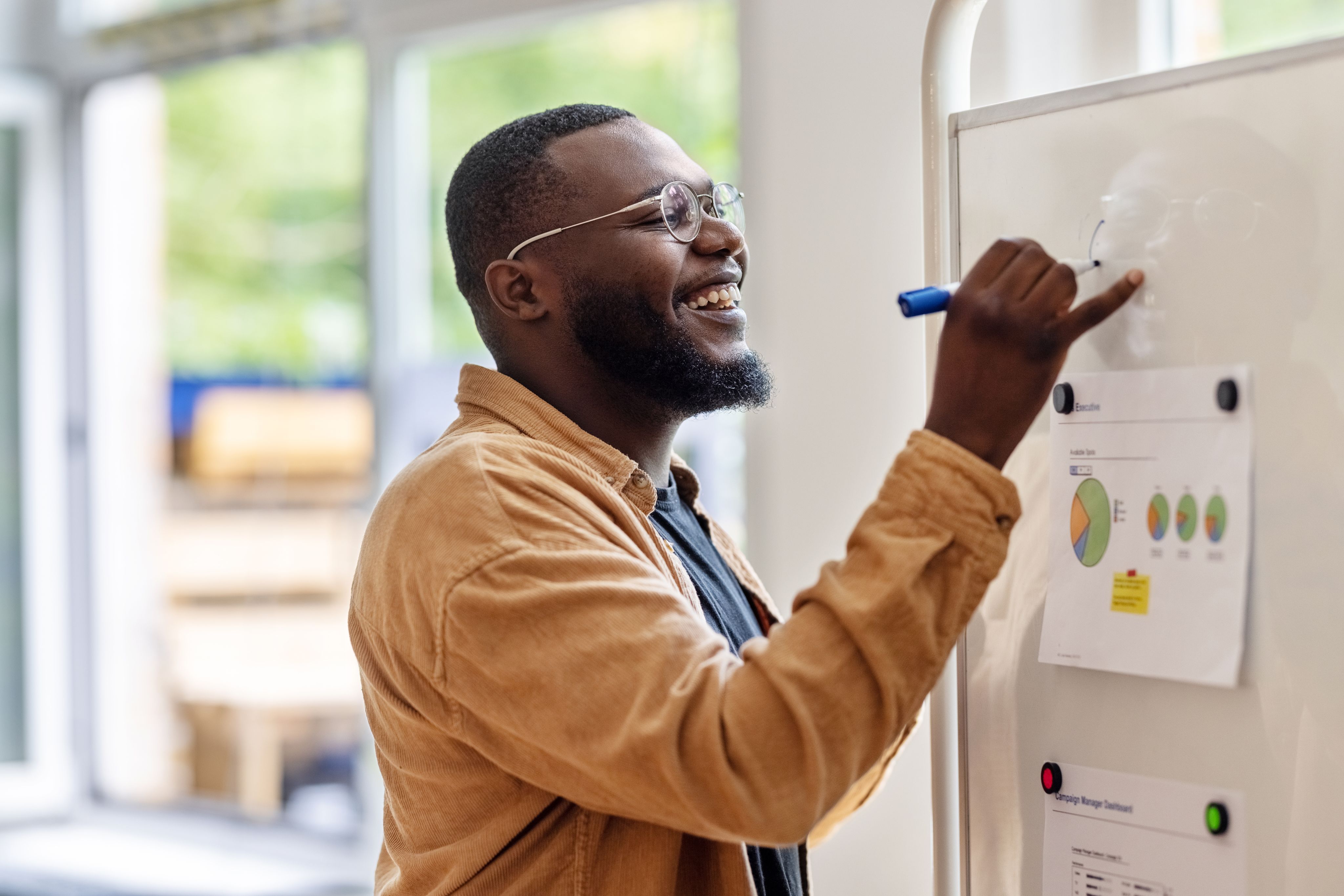Man writing on white board