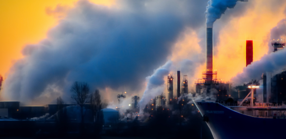 Factory chimneys blowing smoke.