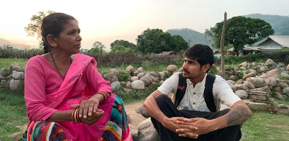 Researcher interviewing a local woman in India