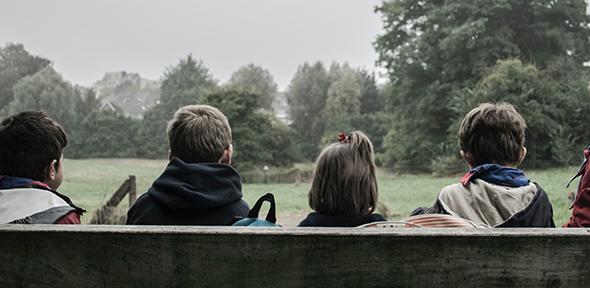 Children sitting on park bench