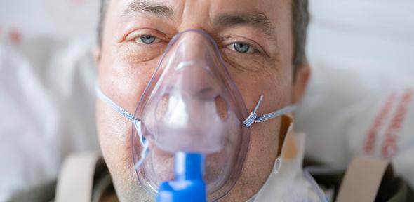 A man with a respirator on his face