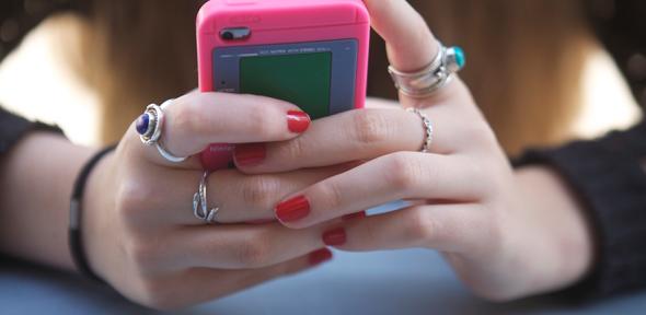 Teenager holding a smartphone