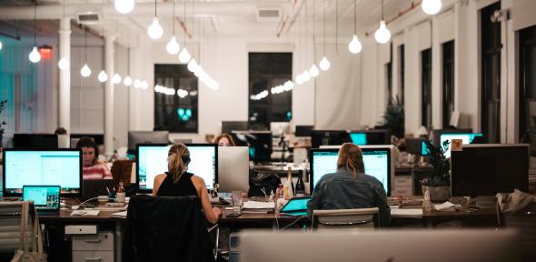 People in office sitting in front of computers