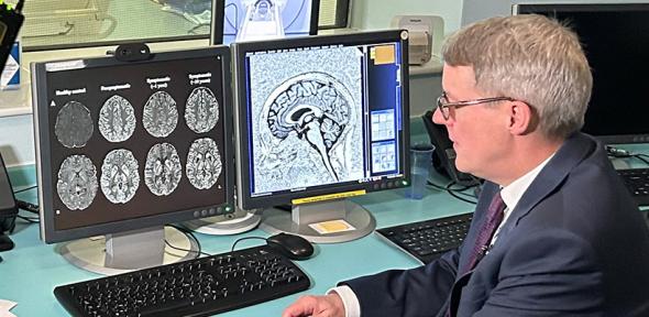 Patrick Chinnery looks at brain scans on a computer screen