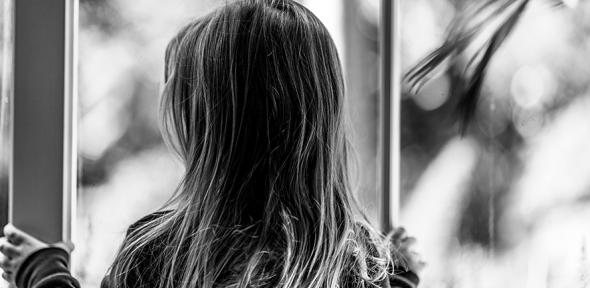 Child looking out of a window