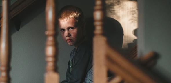 Angry boy on stairs 