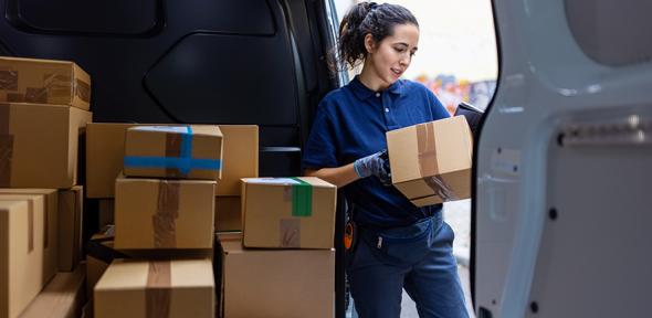 Courier checking parcel for delivery