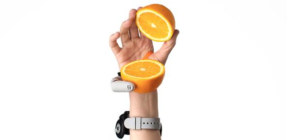 Third Thumb holding a sliced orange