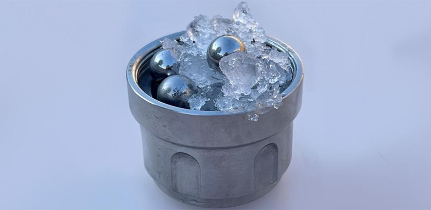 Part of the set-up for creating medium-density amorphous ice: ordinary ice and steel balls in a jar (not amorphous ice)