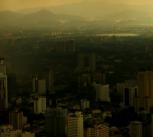 A dark skyline above a polluted cityscape