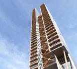 A skyscraper against a blue sky.