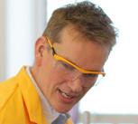 Dr Pete Wothers giving a chemistry demonstration to an audience at the Cambridge Science Festival including David Willetts, Minister for Universities and Science.