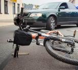 Bicycle lying in the road in front of a car