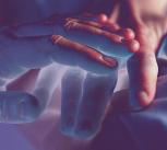 Experimental coloured image of two hands touching
