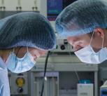 Two researchers wearing masks in operating theatre