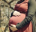 Pregnant woman holding her stomach