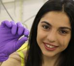 PhD student Maria Kiourlappou holding a piece of SmB6