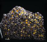 The Esquel pallasite from the Natural History Museum collections, consists of gem-quality crystals of the silicate mineral olivine embedded in a matrix of iron-nickel alloy.