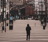 A lone walker in a shopping district of Leeds, UK, during lockdown. 