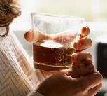 Woman holding a glass of whisky