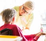 Nurse taking care of elderly sick woman in wheelchair 