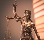 Law books and justice statue