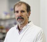 Professor Michele Vendruscolo wearing a white lab coat