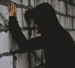 Teenager leaning on a wall