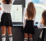 School children watching a sports game from indoors