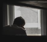 Man looking out of window