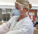 Medical personnel putting on PPE