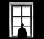 Man standing in front of window