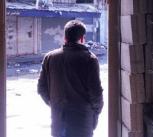 Man framed in pharmacy entrance, in Syria