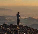 Man in a cowboy hat atop Humphreys Peak in Arizona, US