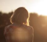 Woman contemplates sunrise