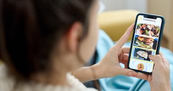 Woman using a food delivery app on her mobile phone