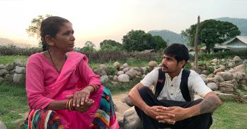 Researcher interviewing a local woman in India