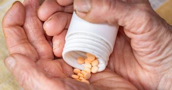 Elderly Woman's Hands and Orange Pills
