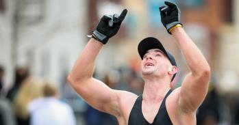 A marathon runner celebrates the moment he crosses the marathon finish line