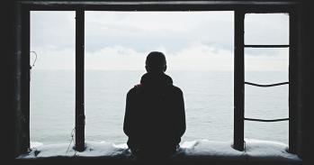 Person looking out through window