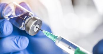 Syringe in bottle of vaccine
