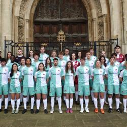 Cambridge football men's and women's team combined stand together