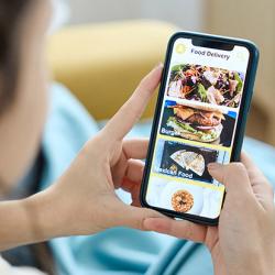 Woman using a food delivery app on her mobile phone