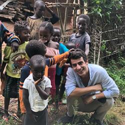 Joao Costa surrounded by children in Guinea-Bissau