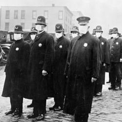 Policemen in Seattle wearing masks made by the Red Cross, during the Spanish Influenza epidemic, December 1918. 