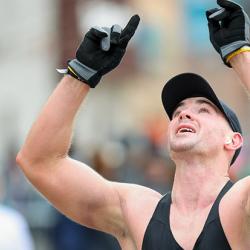 A marathon runner celebrates the moment he crosses the marathon finish line