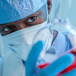 Researcher looking at flask in lab