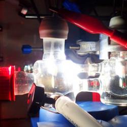 Experimental two-electrode setup showing the photoelectrochemical cell illuminated with simulated solar light