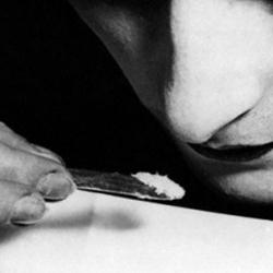 A close up of a young woman snorting cocaine during the 1920s