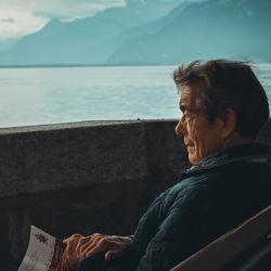Man sitting holding a book